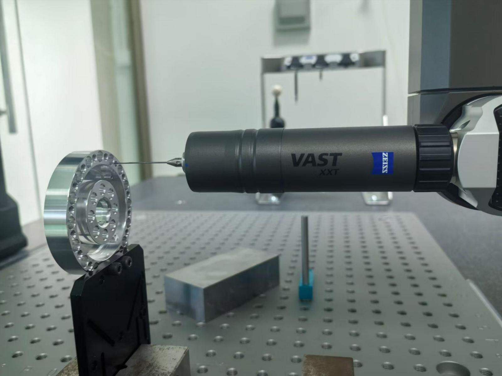 Measurement probe inspecting a circular metal component held in a fixture